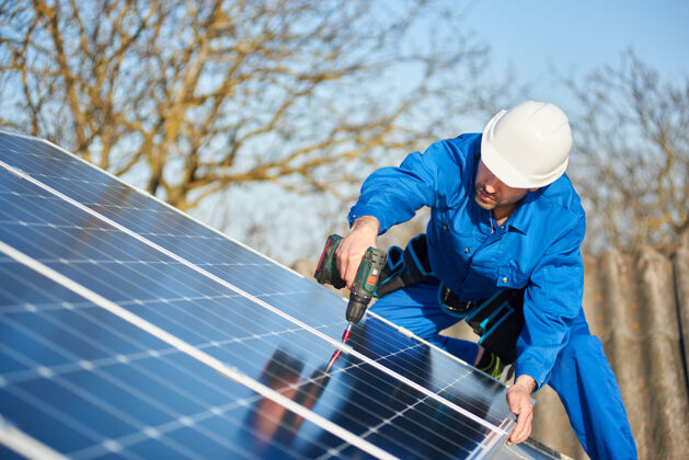 设备电工在现代住宅的屋顶上安装太阳能板住宅房屋阵列