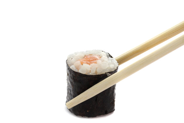 切片三文鱼卷寿司用筷子隔离在白色餐馆晚餐寿司