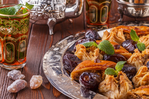 美食摩洛哥薄荷茶在传统的杯子里加糖波斯甜点伊斯兰