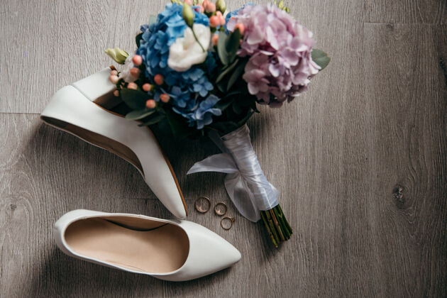 鞋子花束 新娘的鞋子和结婚戒指躺在地板上女朋友约会爱