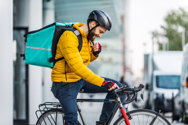 头盔送菜服务 骑手用自行车送菜给客户-关于交通 送菜和技术的概念公司制服订单