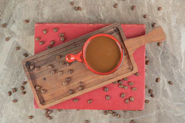 浓缩咖啡在木板上放咖啡豆和书美味营养配料