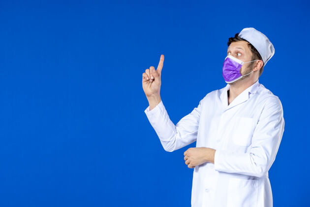 药品身穿医疗服 戴着紫色面罩的男医生正对着蓝色的路边的人说话男医生实验服医院