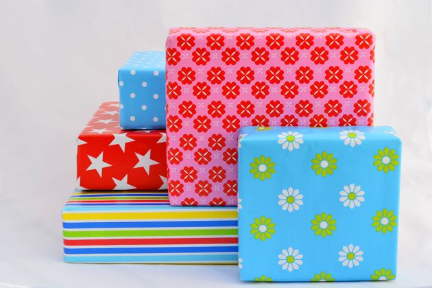 季节孤立的特写镜头的礼品盒在彩色包装堆叠在顶部和旁边的每个桌子地板条纹