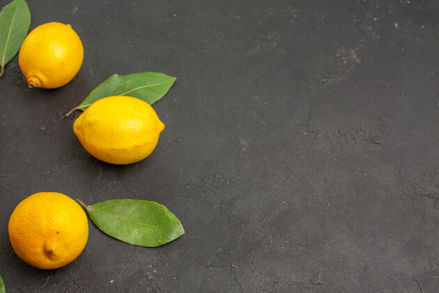 果汁顶视图新鲜的酸柠檬衬在一张深色的桌子上酸橙水果柑橘黄色酸橙黄色健康