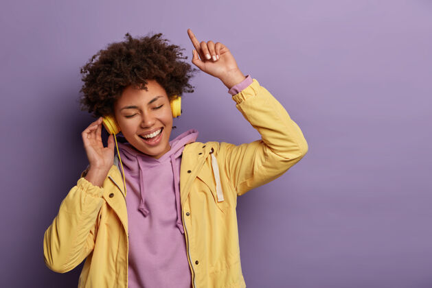 歌曲快乐无忧无虑的女人喜欢新耳机里的音乐声姿势耳机年轻