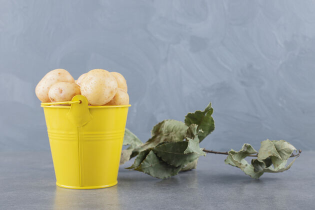 健康一个装满生土豆的黄色桶餐桌维生素鳞茎