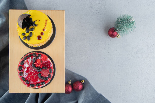 糖在大理石背景上有圣诞装饰的木板上的小蛋糕美味什锦烘焙食品