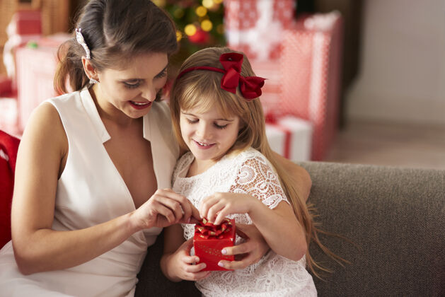手母女俩打开包装好的礼物圣诞树庆祝传统