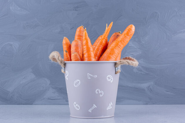 营养大理石背景上的一小桶胡萝卜美味桶装新鲜