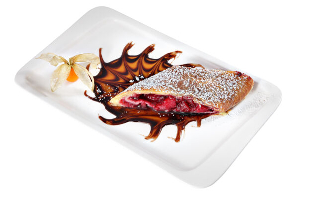 小吃一块撒了糖粉的樱桃馅饼 放在一个长方形的陶瓷板上 隔离在白色的背景上浆果填充蛋糕