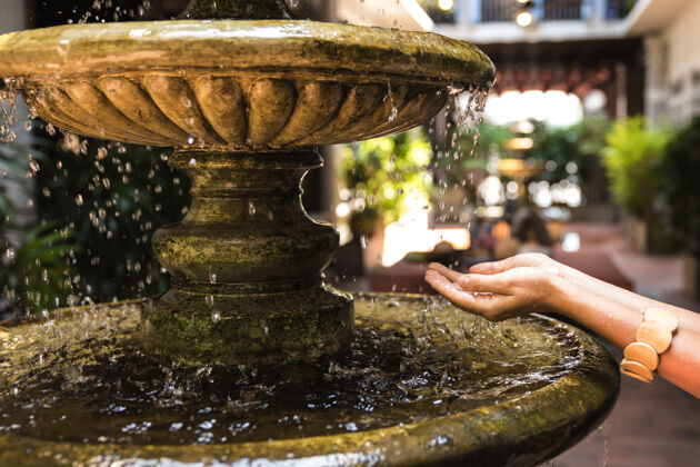滴女人的手和古老的喷泉溅着水滴女人酒店青铜
