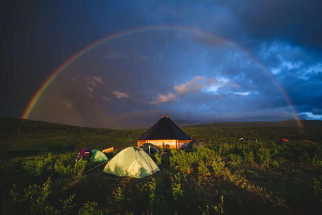 山所有传统的阿尔泰房子和旅游帐篷下的彩虹穹顶在奥古斯基地区的阿尔泰共和国 俄罗斯云帐篷文化