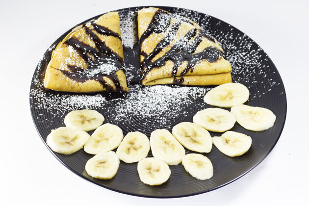 水果巧克力薄饼和香蕉在盘子里 工作室拍摄糖早餐甜食