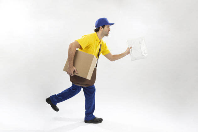 货物邮递员拿着一个包裹在白色的箱子里跑墙.副本空间送货员工人快递员