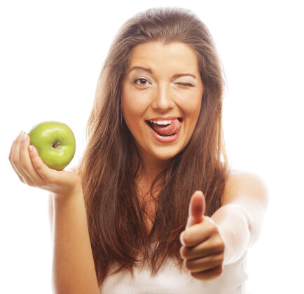 女人拿着青苹果 竖起大拇指的年轻女子饮食感官肩膀
