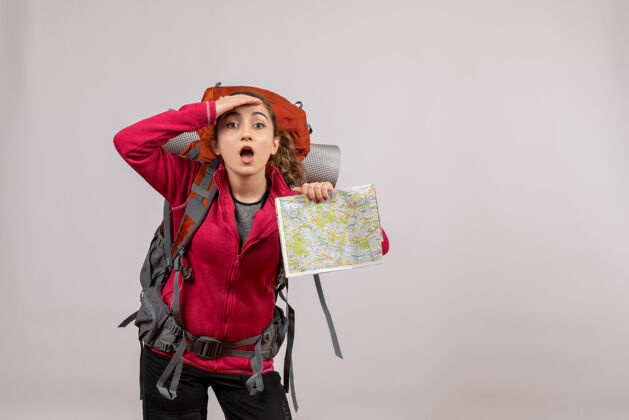 旅游正面图年轻的旅行者背着大背包拿着地图在看什么女人游客肖像