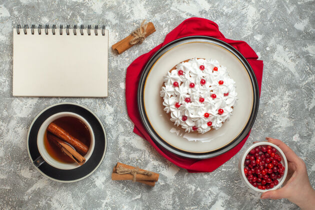 茶美味的奶油蛋糕 用红毛巾和一杯红茶装饰着水果过滤器举行杯