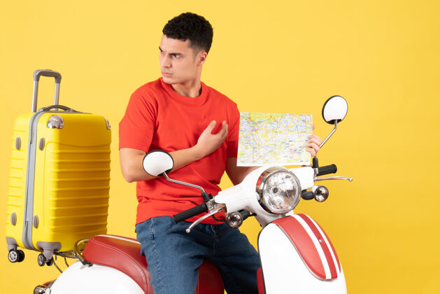 成人正面图：穿着休闲服的年轻旅行者拿着旅游地图坐在轻便摩托车上男视图地图