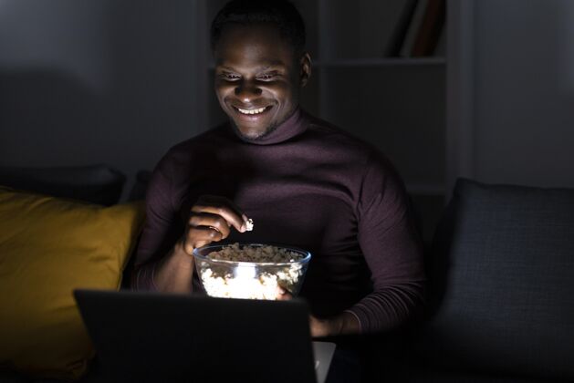客厅一个非洲裔美国人独自在家看netflix舒适Netflix休闲