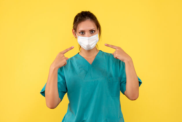 疾病前视图黄色背景上穿着医用衬衫和面罩的女医生面具医疗视图