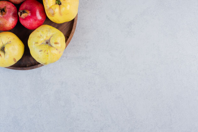 水果木版上新鲜有机苹果木瓜和石榴的特写照片餐桌木瓜水果木瓜