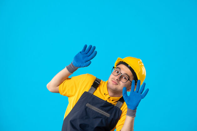 手套身穿制服 戴着手套的蓝色头盔的男性建筑工人的正面图勤杂工男性人