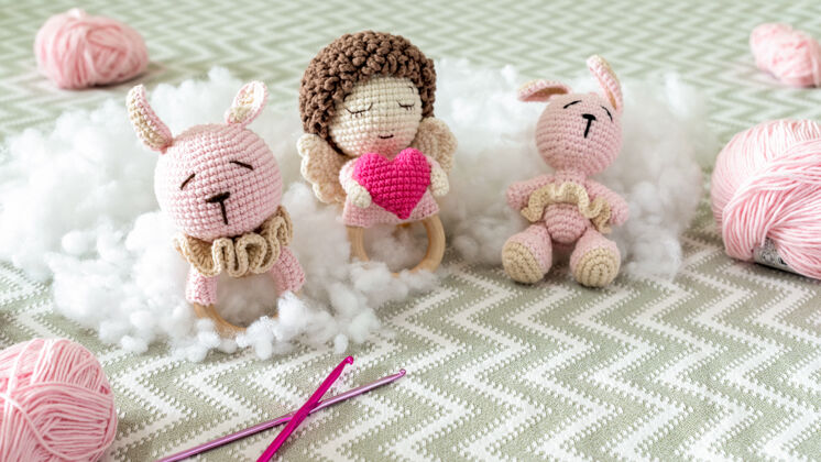天可爱的针织毛绒玩具在沙发上与毛绒周围童年动物友谊