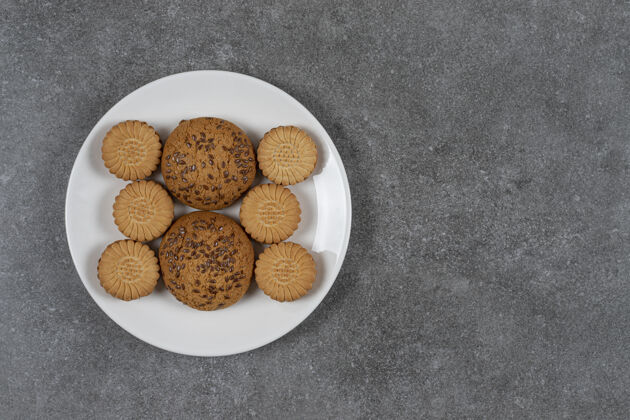 饼干饼干和饼干放在大理石表面的盘子上烘焙食品甜点美味的