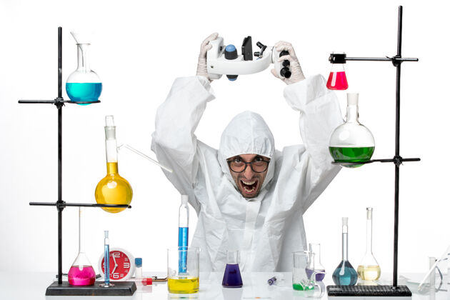 化学正面图穿着特殊防护服手持显微镜的男科学家科学研究显微镜