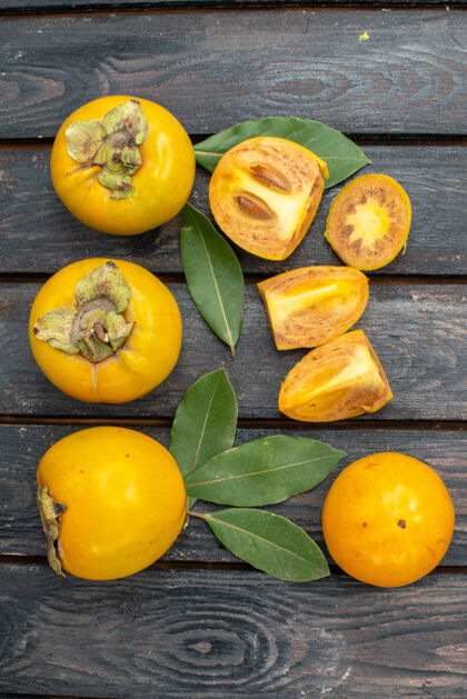 成熟顶视图新鲜甜甜的柿子放在木质质朴的餐桌上 水果成熟醇厚顶部黄色食物