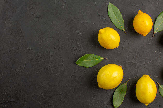 复制空间顶视图新鲜的酸柠檬衬在深色的桌子上 水果柑橘黄色的酸橙深色顶视图黄色