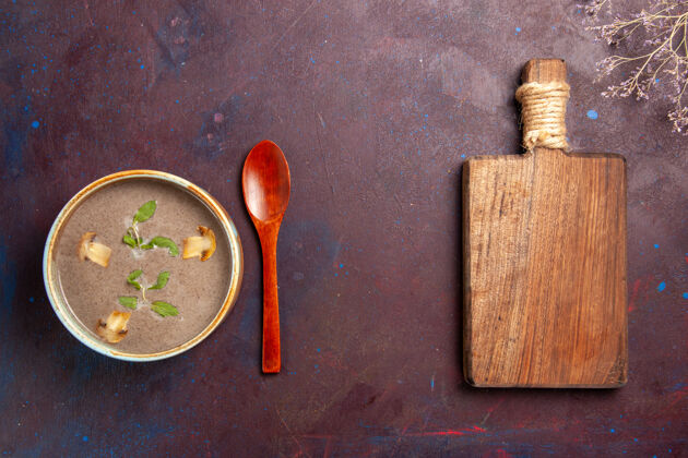盘子顶视图美味的蘑菇汤在盘子里深色的背景上汤蔬菜餐食物晚餐蘑菇螺丝生的
