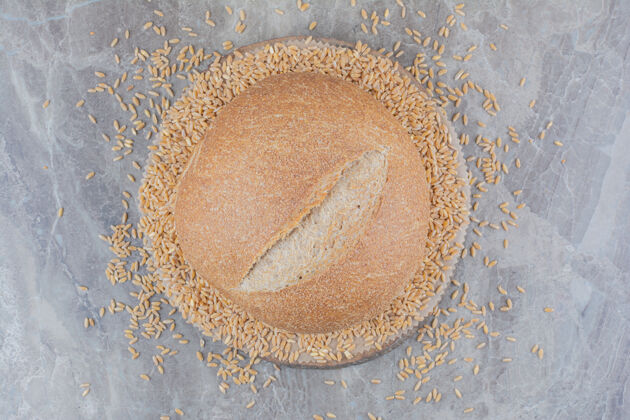 新鲜大理石表面有燕麦粒的新鲜面包燕麦美味大理石