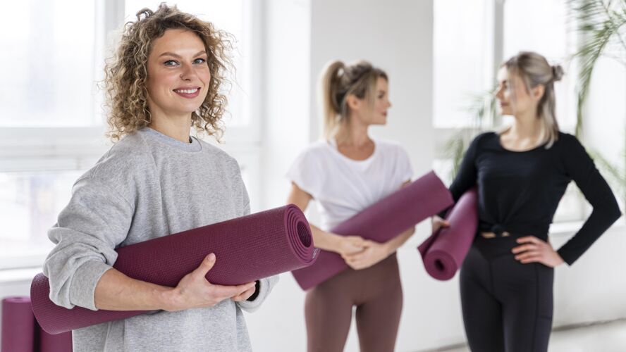 锻炼中镜头笑脸女人瑜伽垫成人运动训练