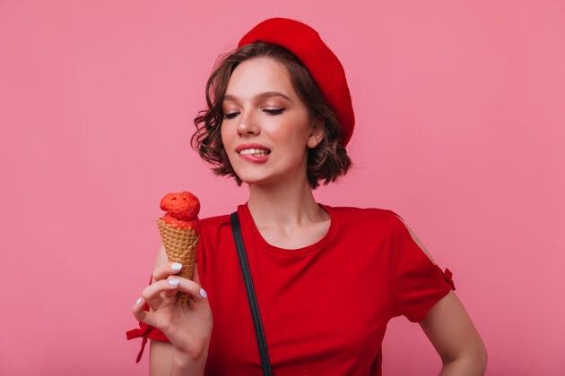 成人灵感来源于波浪发型的女模特微笑着看着冰淇淋穿着贝雷帽享受甜点的性感法国女孩女性室内欧洲