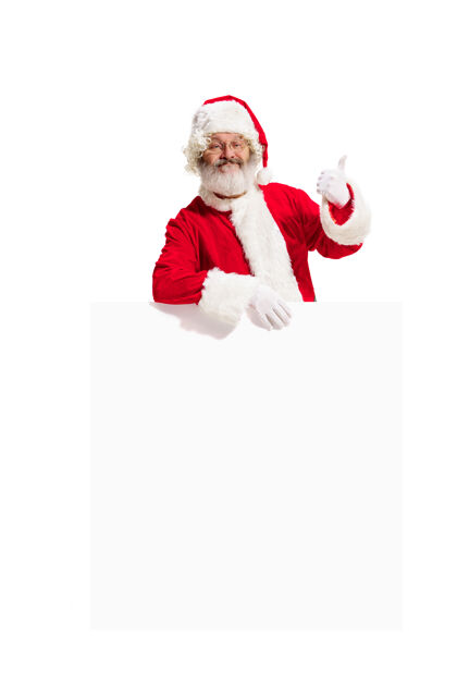诺埃尔快乐惊喜的圣诞老人指着空白的广告横幅背景和复制空间微笑的老人在白色空白的空白海报显示节日白色人
