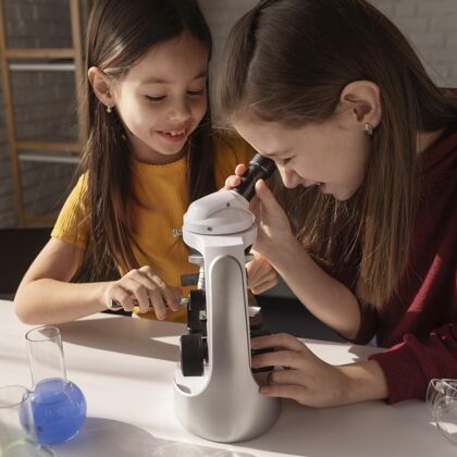 科学特写镜头女孩用显微镜工作学生孩子实验