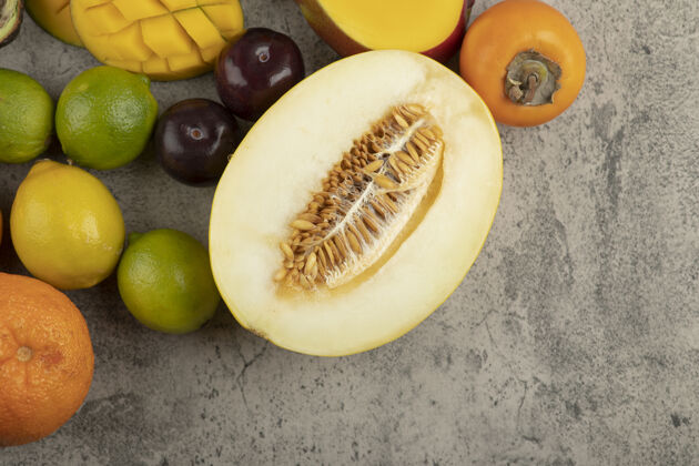 柠檬大理石表面堆满了新鲜的水果成分美味柿子鳄梨