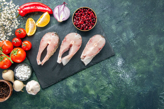 膳食顶视图新鲜鱼片与红色番茄在黑暗的背景海鲜海洋肉类海餐菜沙拉水胡椒番茄海洋海鲜