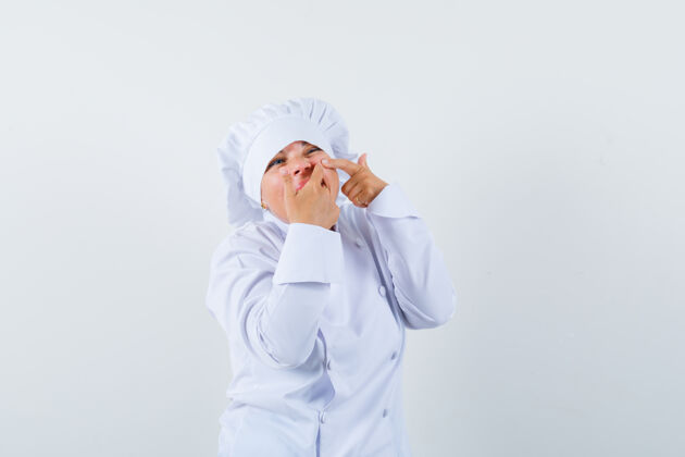 欢呼一个穿着白色制服的女厨师在脸颊上挤痘痘年轻粉刺休闲