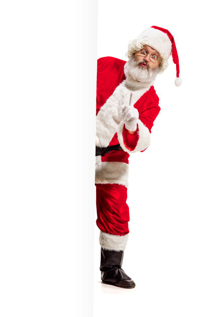 圣诞老人惊喜的圣诞老人指着空白广告礼物惊讶诺埃尔