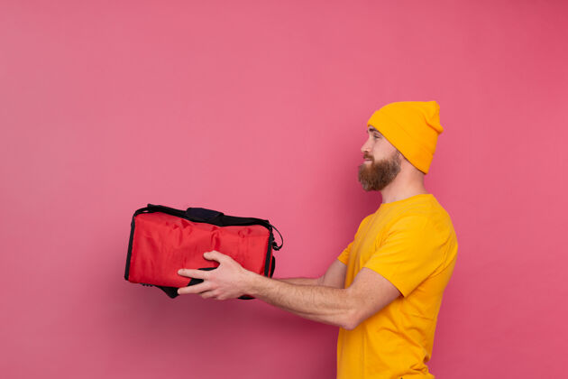 运输一个留着胡须的欧洲送货员 手里拿着一盒粉红色的食物男人发货交付