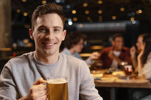特写特写笑脸男人拿着啤酒杯一起室内饮料