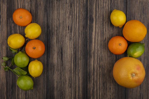 复制顶视图复制空间葡萄柚与橙子柠檬和酸橙木背景空间葡萄柚水果