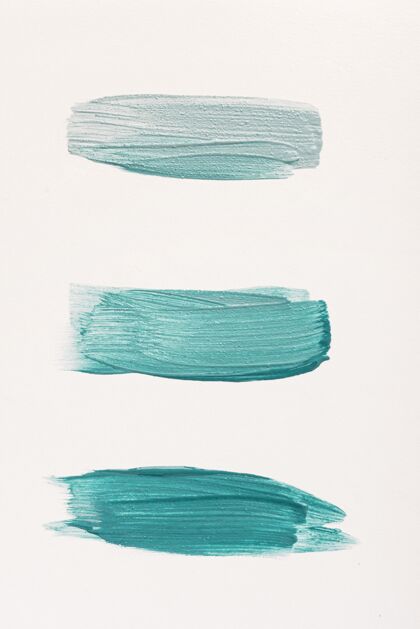 平滑度平铺的三个蓝色油漆刷笔划液体颜料蓝色