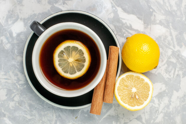杯子顶视图一杯茶 白色表面有肉桂和柠檬柑橘健康甜橙