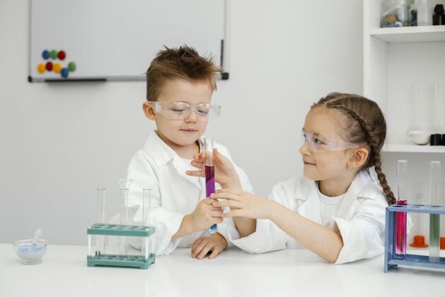 水平年轻的男女科学家在实验室里用试管做实验试管实验室外套男孩