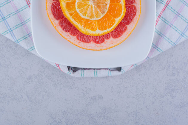 葡萄柚在白色盘子上放几片新鲜的柚子 橘子和柠檬柠檬柑橘食用