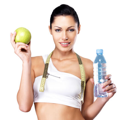 女人一个健康的女人的肖像与苹果和一瓶水健康的健身和饮食生活方式的概念女孩运动瓶子